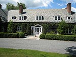 house front with new entrance terrace and boxwood hedges